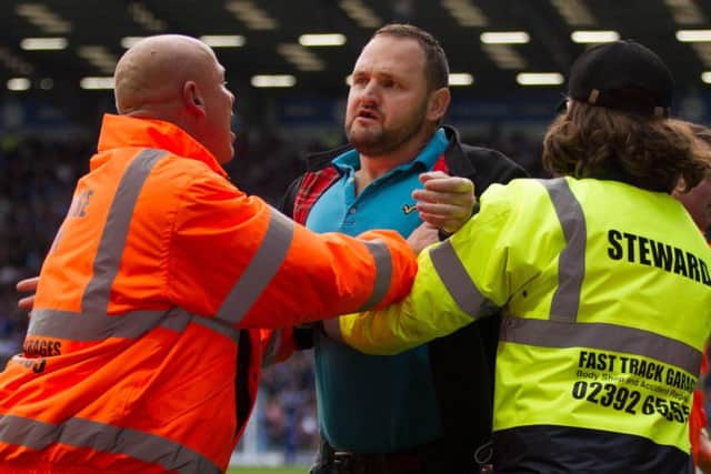Wesley Young being held back by stewards at Fratton Park. Picture: Dave Taylor