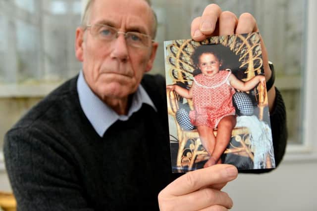 Richard Lee with a photograph of his daughter Katrice aged 18 months