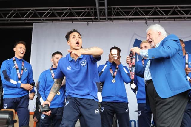 Kyle Bennett takes Iain McInnes' wallet during the League Two title-winning celebrations. Picture: Joe Pepler