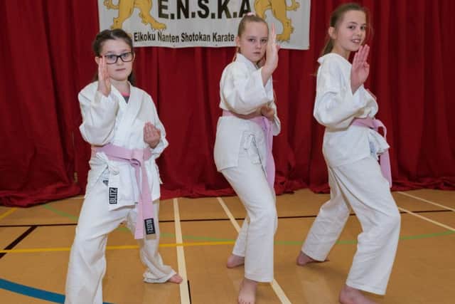 Kara Cook, eight, Elise-Marie Oliver, 10, and Kacie Keens, 10, take part in the grading. Picture: Vernon Nash