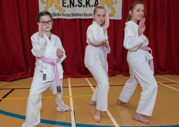 Kara Cook, eight, Elise-Marie Oliver, 10, and Kacie Keens, 10, take part in the grading. Picture: Vernon Nash