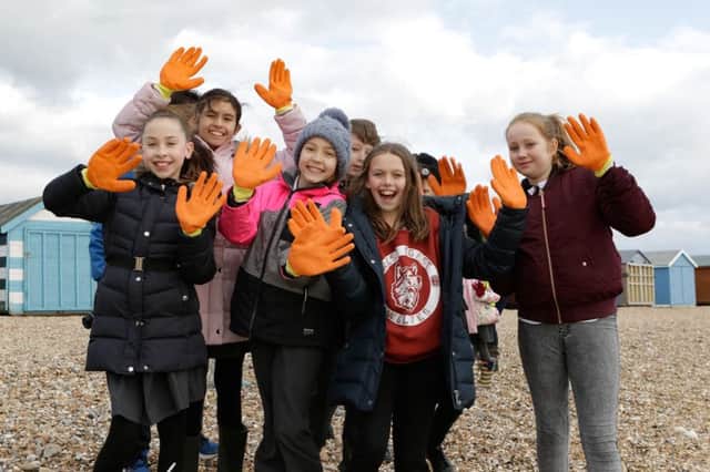 Primary school youngsters put on their safety gloves for the beach clean       mikeowensphotography.com