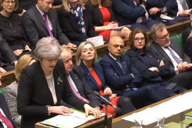 Prime Minister Theresa May speaks during Prime Minister's Questions in the House of Commons yesterday, with Portsmouth North MP Penny Mordaunt seated, right