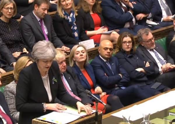 Prime Minister Theresa May speaks during Prime Minister's Questions in the House of Commons yesterday, with Portsmouth North MP Penny Mordaunt seated, right