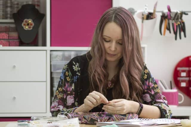 Designer Chloe Menage making the beaded Jane Austen pendants