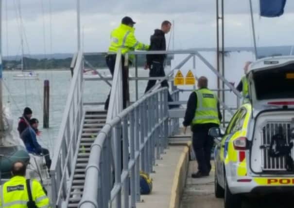 An unidentified man being led from a Border Force vessel at Sparkes Marina in Hayling Island in May 2017. Picture: Tanya Farne