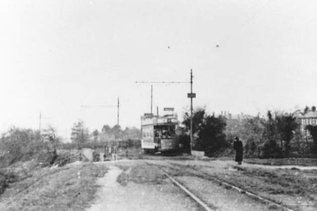 Somewhat faded but still recognisable, a tram crosses the bridge over Southwick Hill Road, Cosham.  Picture: Barry Cox Collection