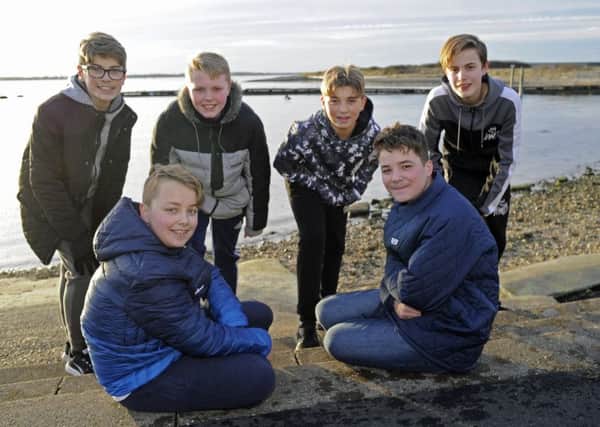 Josh Spaven, front left, with his twin brother Aaron who was rescued by a group of pals after he fell into the sea at Tipner  from left:  Bradley Willmott, Sam Ward, Kai Renault and James Humpleby                                Picture: Ian Hargreaves (180197-1)
