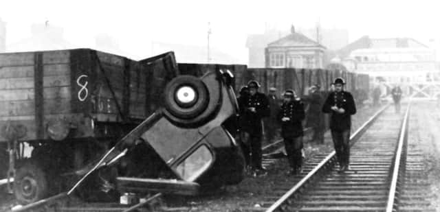 The doctors car under the wheels of a five-plank wagon. He escaped with minor injuries.