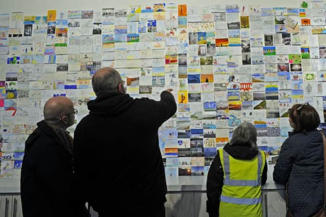 People enjoying looking at the postcards
