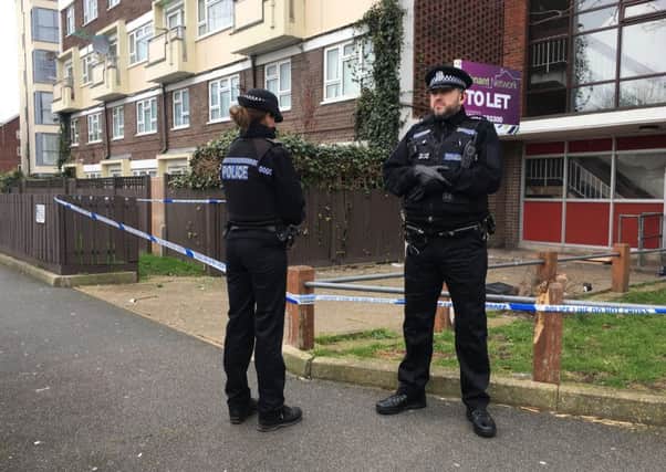 Officers stand guard outside Oldbury House, in Sackville Street, Southsea, after a teenager was found seriously-injured