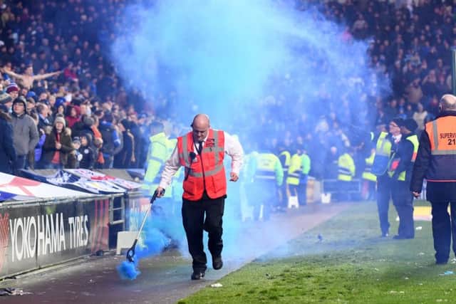Smoke from a flare at the MK Dons v Pompey match on Saturday. Picture: Jane Russell