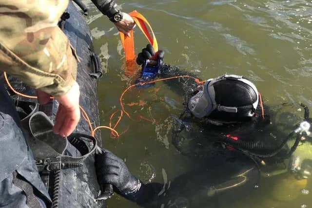Image attached shows the Royal Navy bomb disposal team at the scene **plus one stock image too MORE IMAGES TO COME LATER****Royal Navy bomb disposal experts are working alongside the Metropolitan Police to safely remove a Second World War device found in the River Thames.