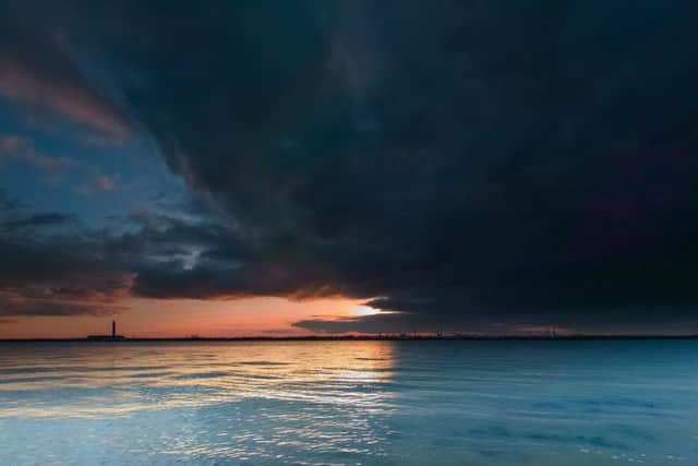 Fawley Refinery at sunset with dramatic sky and slow shutter speeds