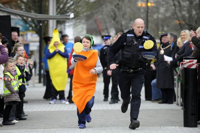 Anna Lewkowicz from Havant Borough Council running against PC Terry Burke from Hampshire Police at a previous race at Waterlooville Precinct. Credit: Allan Hutchings