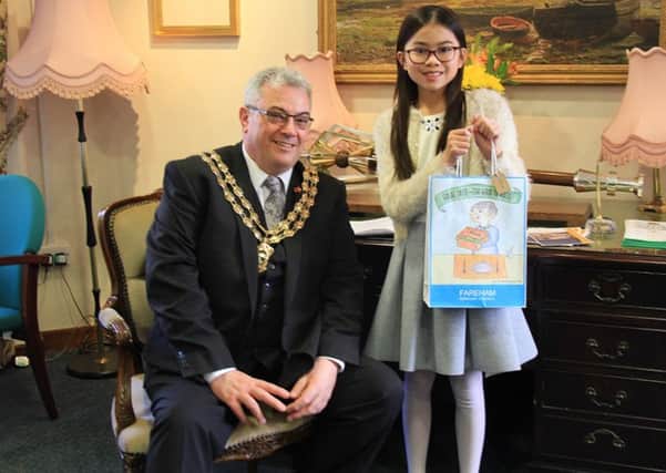 Mayor of Fareham, Councillor Geoff Fazackarley and Enya Chui with her winning bag design.

Picture: Fareham Borough Council