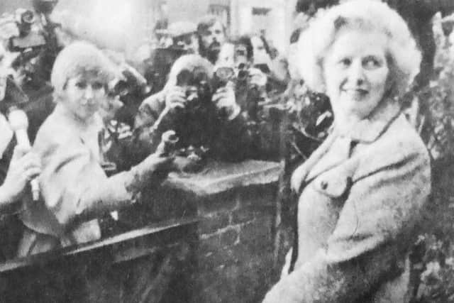 Margaret Thatcher is greeted by newsmen as she leaves her Chelsea home