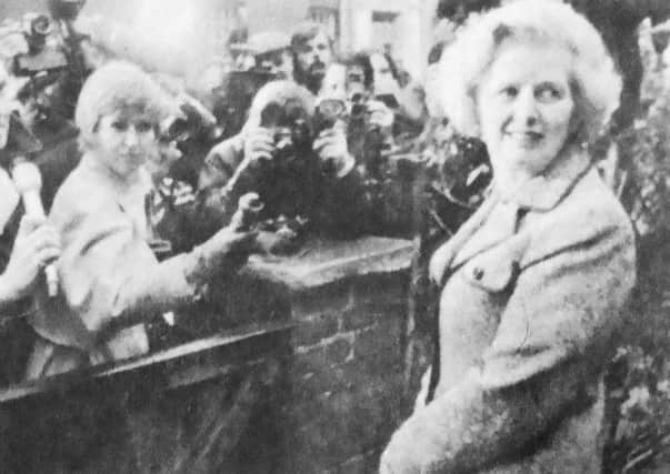 Margaret Thatcher is greeted by newsmen as she leaves her Chelsea home