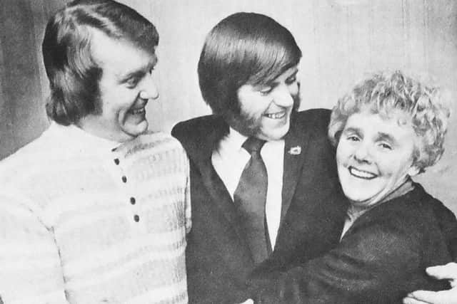 David Curwen, centre, hugs his mother with whom he wa sreunited. Completing the group is his brother Keith