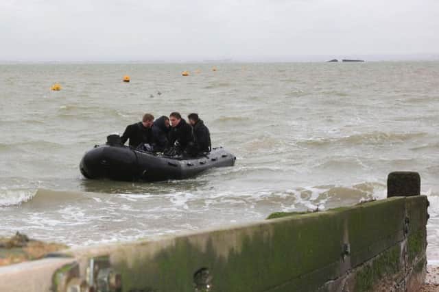 Divers return to the shore after successfully destroying the Second World War bomb. Picture: Royal Navy