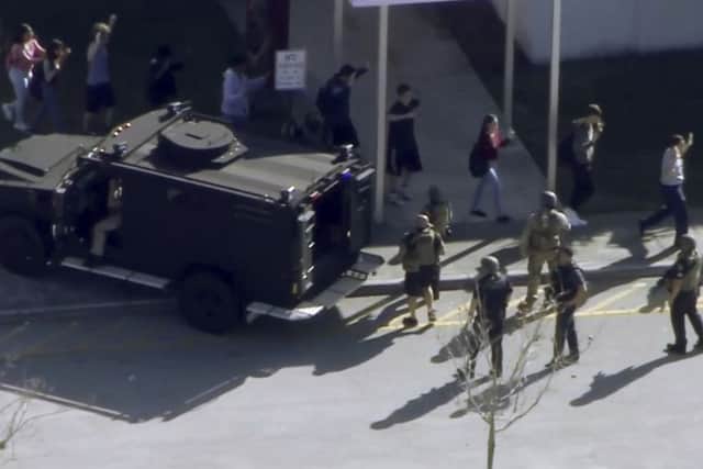Students from the Marjory Stoneman Douglas High in Parkland, Florida, evacuating the school after the shooting