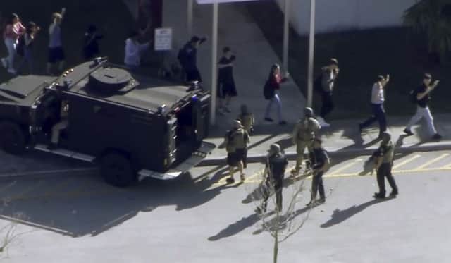 A picture from WPLG-TV of students from the Marjory Stoneman Douglas High in Parkland, Florida, evacuating the school following a shooting