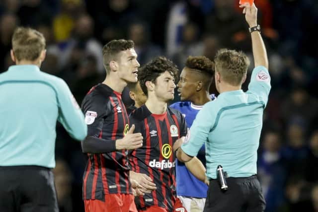 Lee Travis is shown a red card by referee Oliver Langford