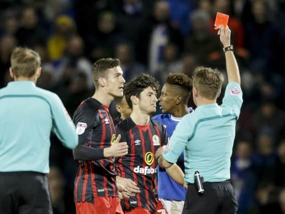 Lee Travis is shown a red card by referee Oliver Langford