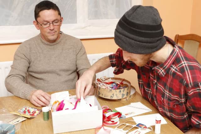 Clients Jason Harrison and Ben Weeks making Christmas cards, one of the activities provided by the winter shelter service