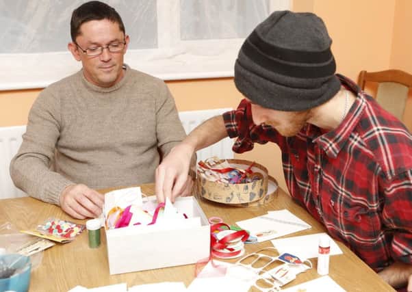 Clients Jason Harrison and Ben Weeks making Christmas cards, one of the activities provided by the winter shelter service