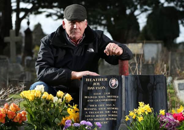 Dave Davison at the grave of his wife, Heather, at Anne's Hill Cemetery, Gosport, where his flowers were stolen     Picture: Chris Moorhouse