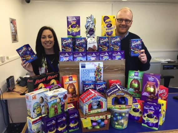 Eliza Dunn from Rowans Hospice, left, and Arran Jerred from Access Self Storage Portsmouth with some of the 152 Easter Eggs collected for Rowans Hospice in last years Access Self Storage charity Easter Egg Appeal