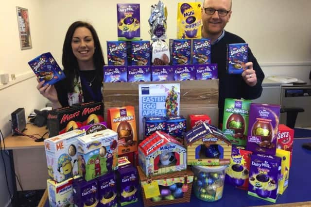 Eliza Dunn from Rowans Hospice, left, and Arran Jerred from Access Self Storage Portsmouth with some of the 152 Easter Eggs collected for Rowans Hospice in last years Access Self Storage charity Easter Egg Appeal