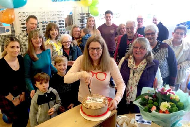 Anne Gill cutting the birthday cake surrounded by staff, clients and well-wishers.Over 100 guests attended the celebrations for the fifth birthday of Portsmouths leading independent opticians, Anne Gill Eyecare