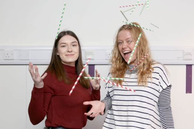 .
Students Patrycja Sobczyk and Tyler Scoble pictured with the paper straws at Portsmouth University Library Picture: Habibur Rahman