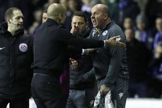 Paul Cook, right, and Pep Guardiola go head to head on the touchline during last night's FA Cup tie between Wigan and Manchester City