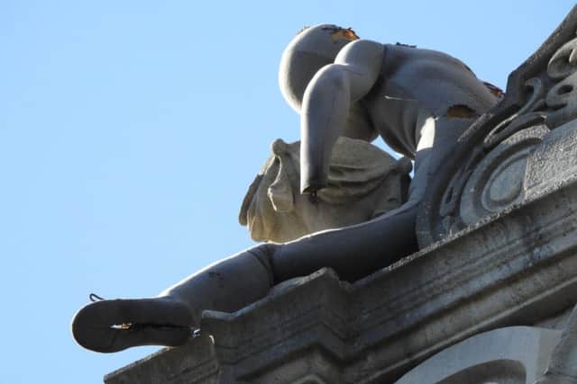 The bizarre figure perched on top of Charter House. Credit: Julie Potten