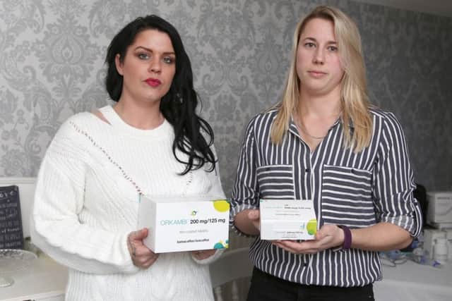 Gemma Weir and Michelle Frank with the medication they want to see prescribed by the NHS