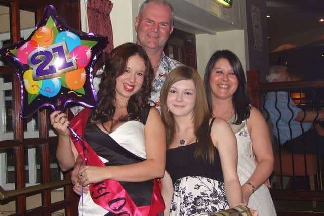 Kerry Harvey (left) with her mum Eileen (right) and her dad and sister Amy on her 21st birthday