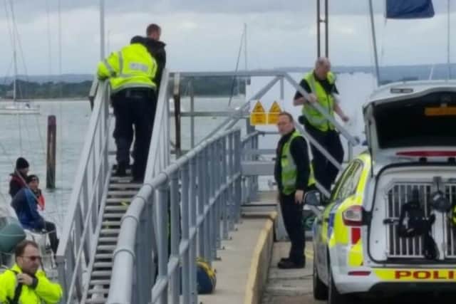 An unidentified man being led from a boat at Sparkes Marina. Picture: Tanya Farne