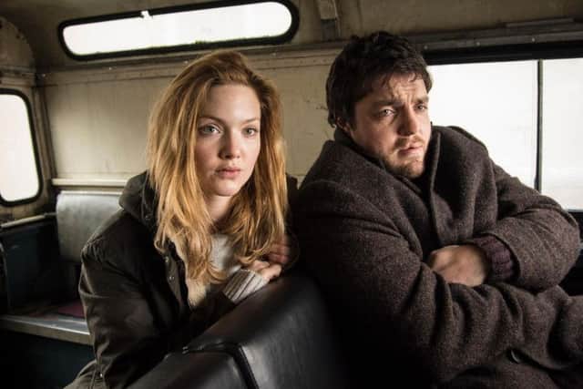 Tom Burke as Comoran Strike with co-star Holliday Grainger, who plays Robin.