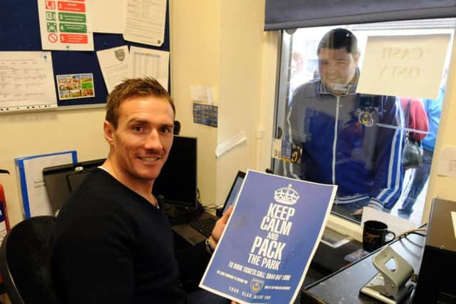 Liam Lawrence helping out in the ticket office at Fratton Park