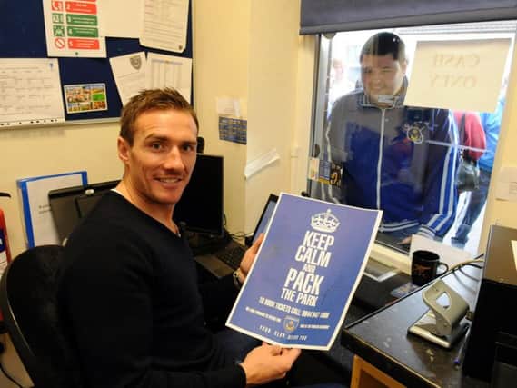Liam Lawrence helping out in the ticket office at Fratton Park