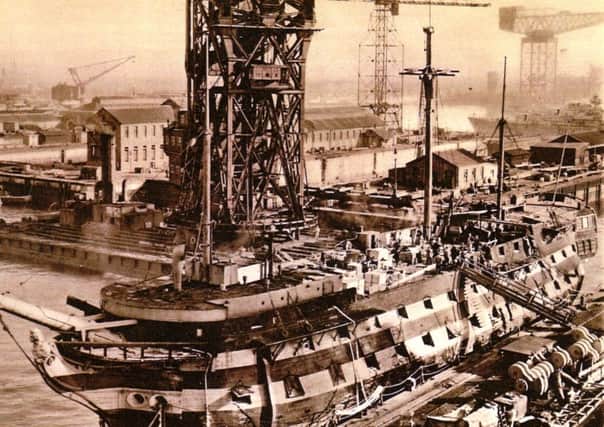 It is 1949 and HMS Implacable has her heart ripped out as her main mast is lifted from her hull.  Picture: Robert James Collection
