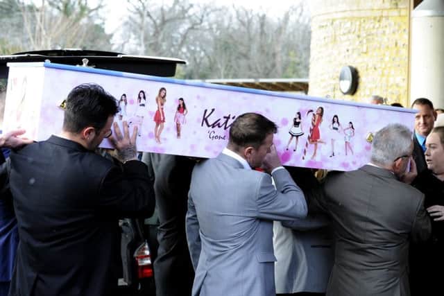 Katie Scannell's bright pink casket is carried into the crematorium. Picture by Malcolm Wells