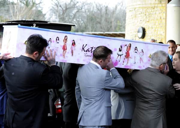 Katie Scannell's bright pink casket is carried into the crematorium. Picture by Malcolm Wells