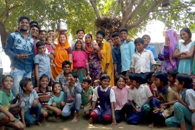 Jessica Erdogan, 23, from Gosport, visited India as part of the International Citizen Service. Jessica is pictured in orange clothing with the pot on her head