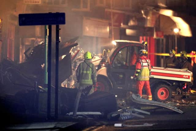 Emergency personnel load a small truck with debris at the scene on Hinckley Road in Leicester, after a "major incident" was declared by police after reports of an explosion at around 7.03pm, Photo: Aaron Chown/PA Wire POLICE_Explosion_224940.JPG