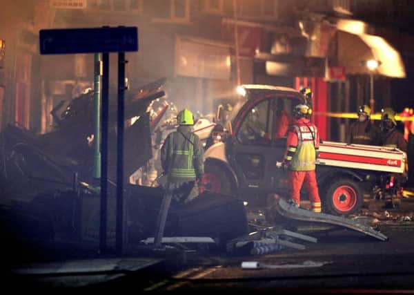 Emergency personnel load a small truck with debris at the scene on Hinckley Road in Leicester, after a "major incident" was declared by police after reports of an explosion at around 7.03pm, Photo: Aaron Chown/PA Wire POLICE_Explosion_224940.JPG