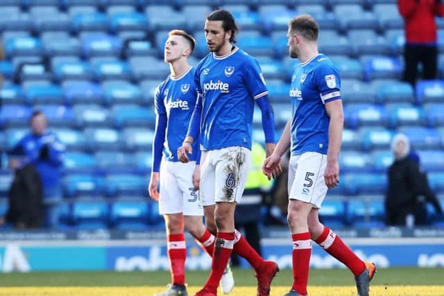 The Pompey players leave the pitch on Saturday amid empty seats at Fratton Park Picture: Joe Pepler